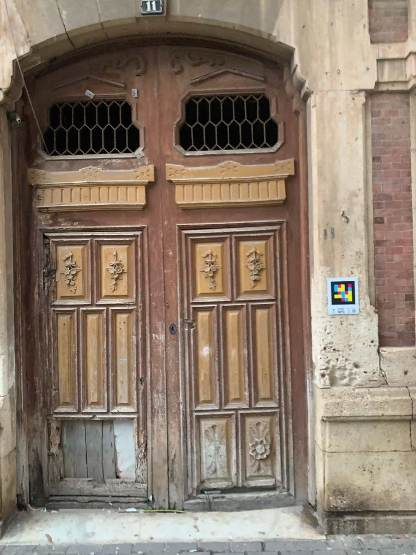 Historic gate of the old town of Águilas with a tourist NaviLens code beside the façade