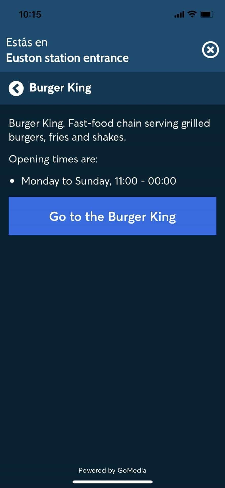 Burger King detail card in the app from Euston station entrance: description, opening hours «Monday to Sunday 11:00 — 00:00» and large «Go to the Burger King» CTA. Powered by GoMedia.