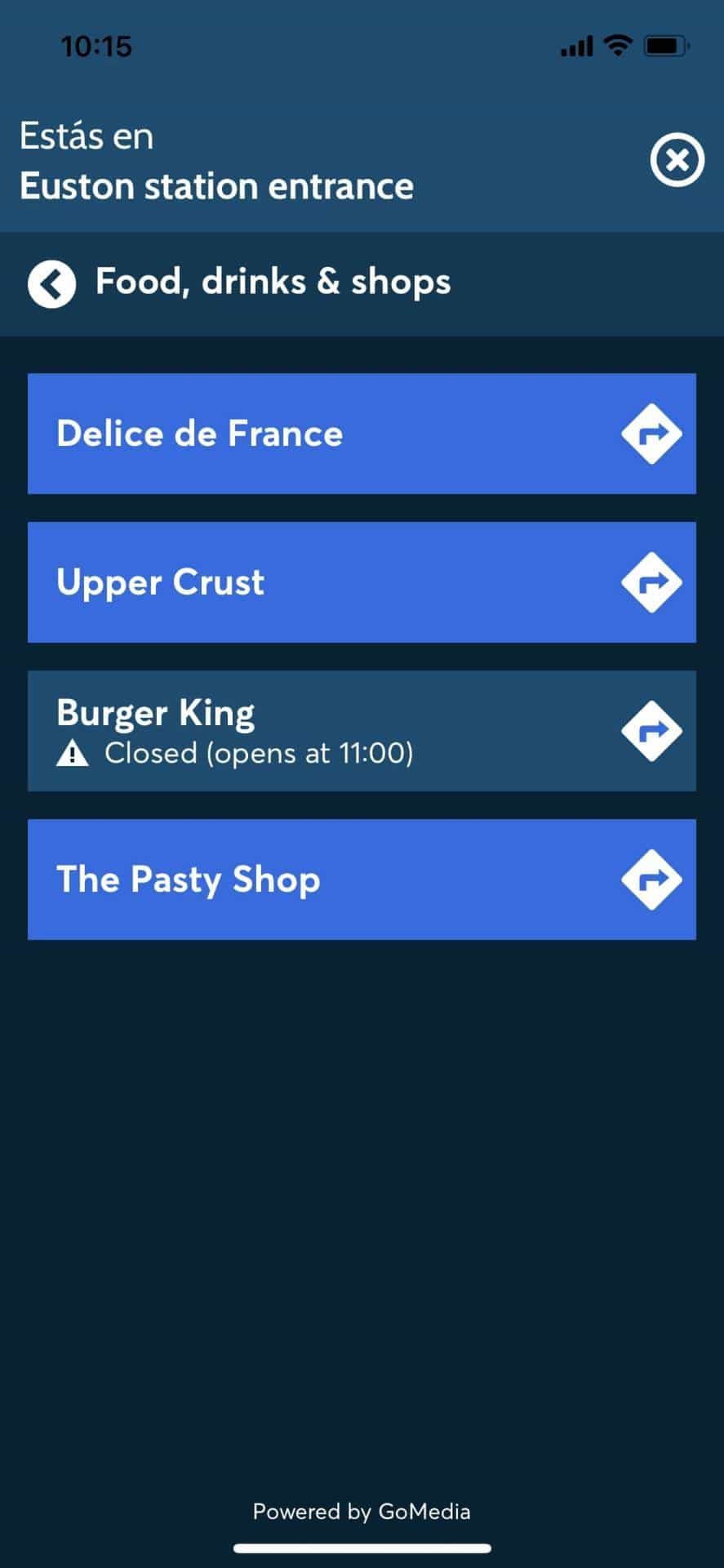 «Food, drinks & shops» listing at Euston station entrance inside the app: Delice de France, Upper Crust, Burger King, The Pasty Shop — each one is a NaviLens navigable route. Powered by GoMedia.