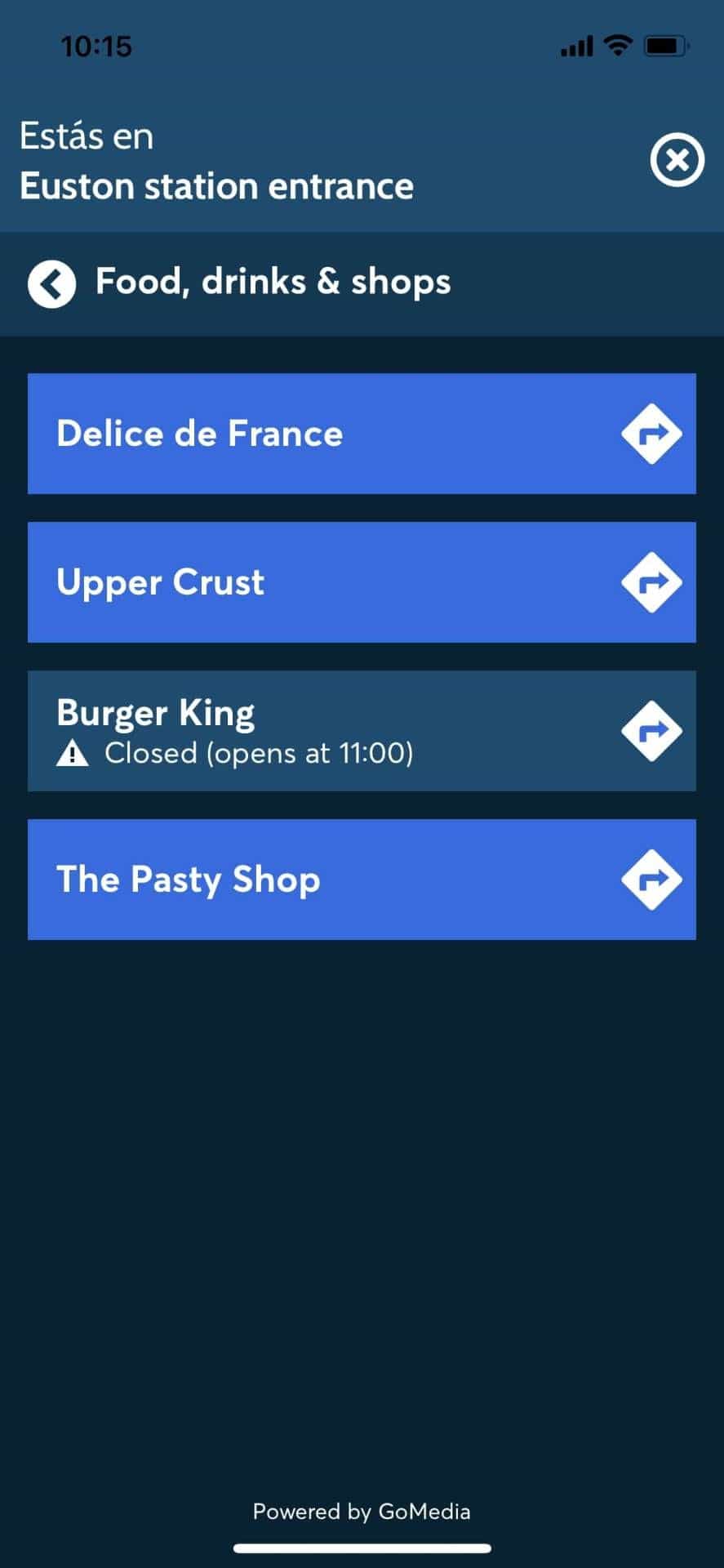 «Food, drinks & shops» listing at Euston station entrance inside the app: Delice de France, Upper Crust, Burger King, The Pasty Shop — each one is a NaviLens navigable route. Powered by GoMedia.