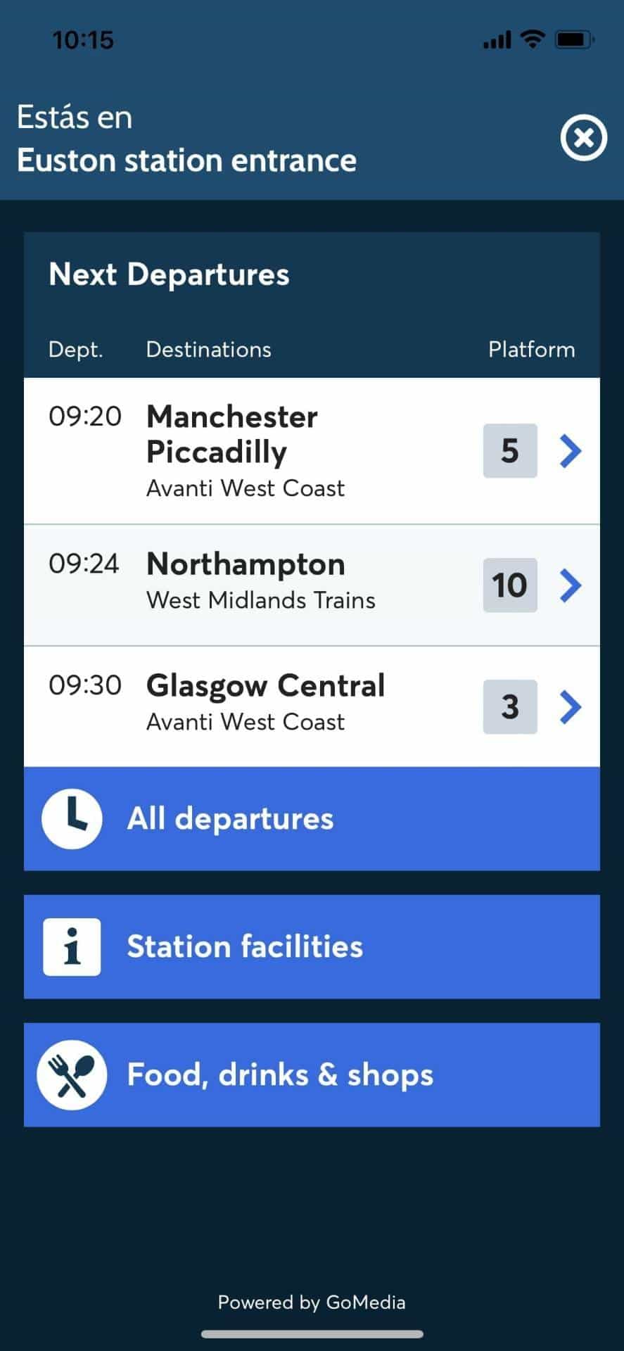 Wayfinding app main screen at Euston station entrance with live «Next Departures» (09:20 Manchester Piccadilly platform 5 — Avanti West Coast; 09:24 Northampton platform 10; 09:30 Glasgow Central platform 3). Powered by GoMedia.