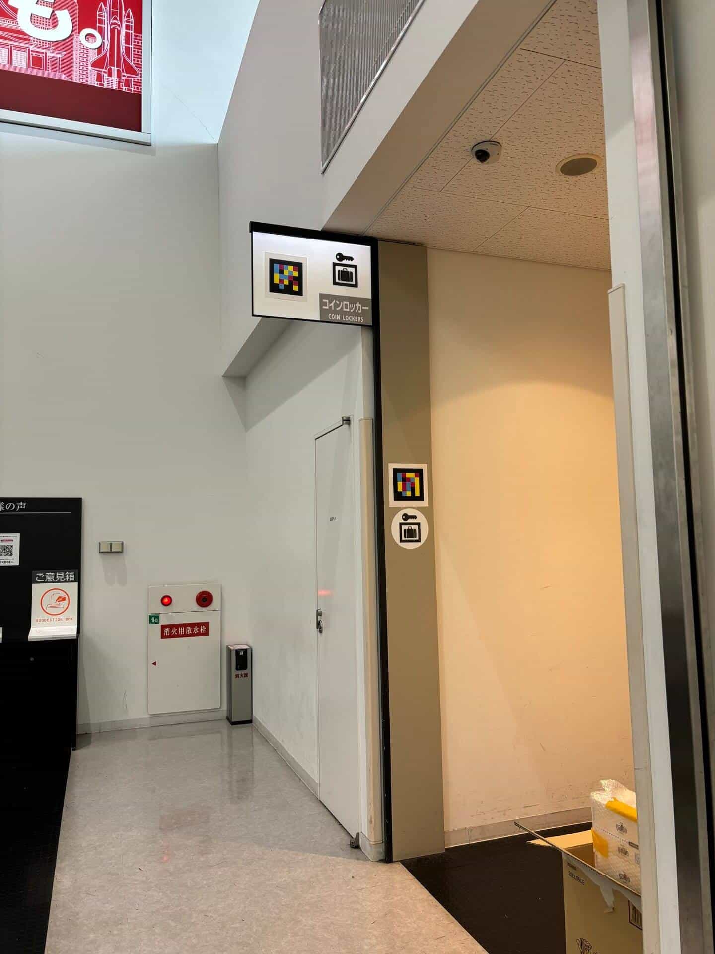 Side corridor at Kobe Airport leading to the coin lockers: two NaviLens tags at different heights