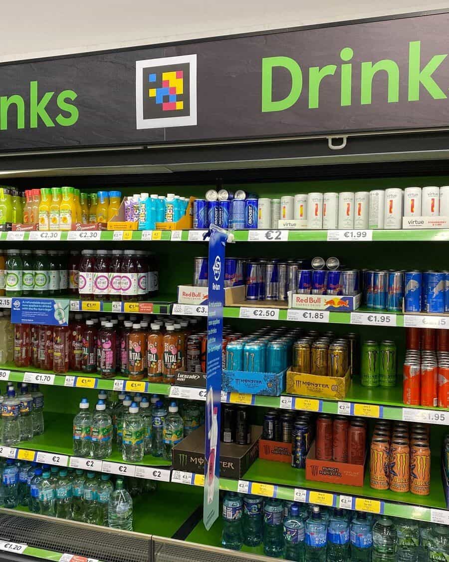 Shopper in a grocery aisle scanning a product on the shelf with her phone while a colorful NaviLens code appears on screen