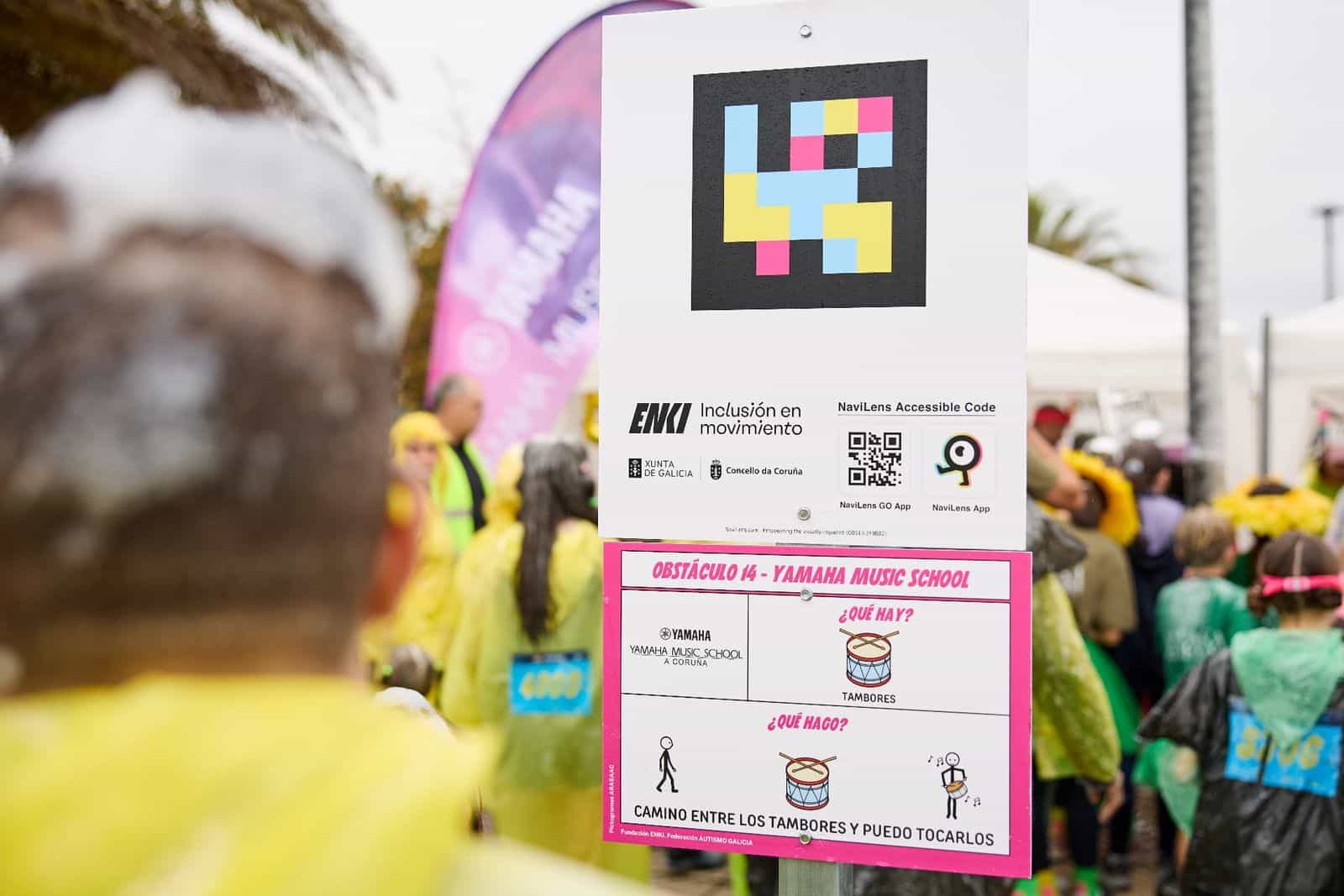 Eingangsbogen El Corte Inglés und NaviLens-Accessible-Code-Tafel mit ARASAAC-Piktogrammen am Hindernis Pompalia bei der Carrera ENKI 2024 in A Coruña