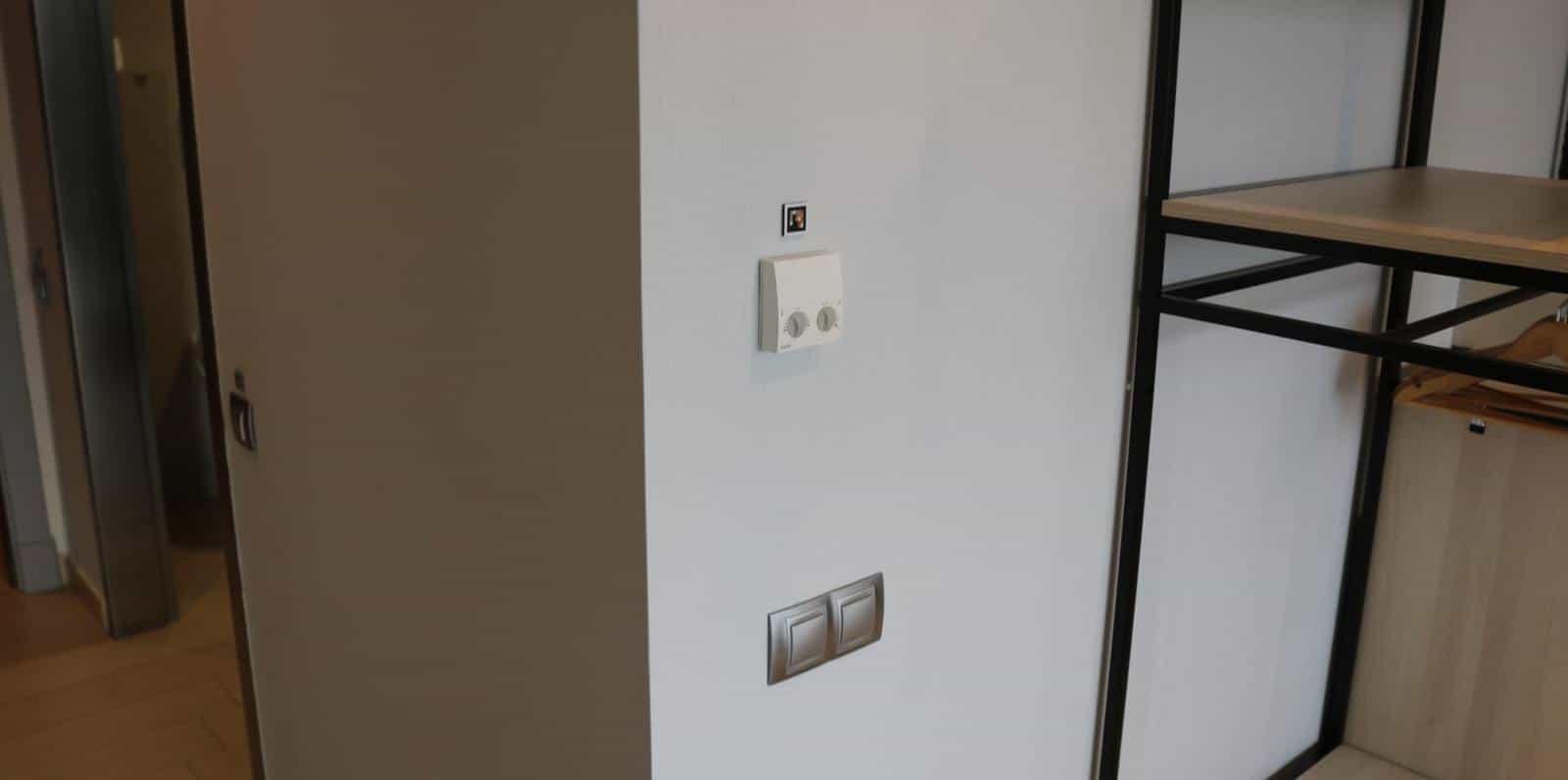 Thermostat and switches on the interior wall of a room at the AR Diamante Beach, with a small NaviLens code next to the thermostat