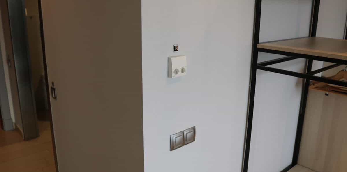 Thermostat and switches on the interior wall of a room at the AR Diamante Beach, with a small NaviLens code next to the thermostat