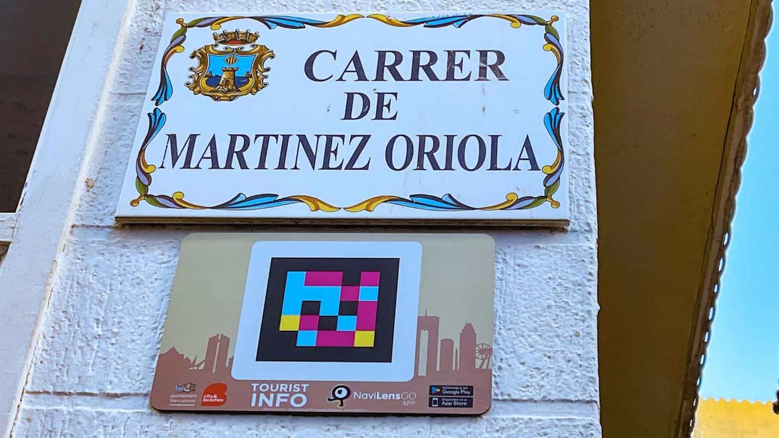 Keramik-Straßenschild Carrer de Martínez Oriola in Benidorm mit NaviLens-Tourist-Info-Code „city & beaches“ der Stadtverwaltung
