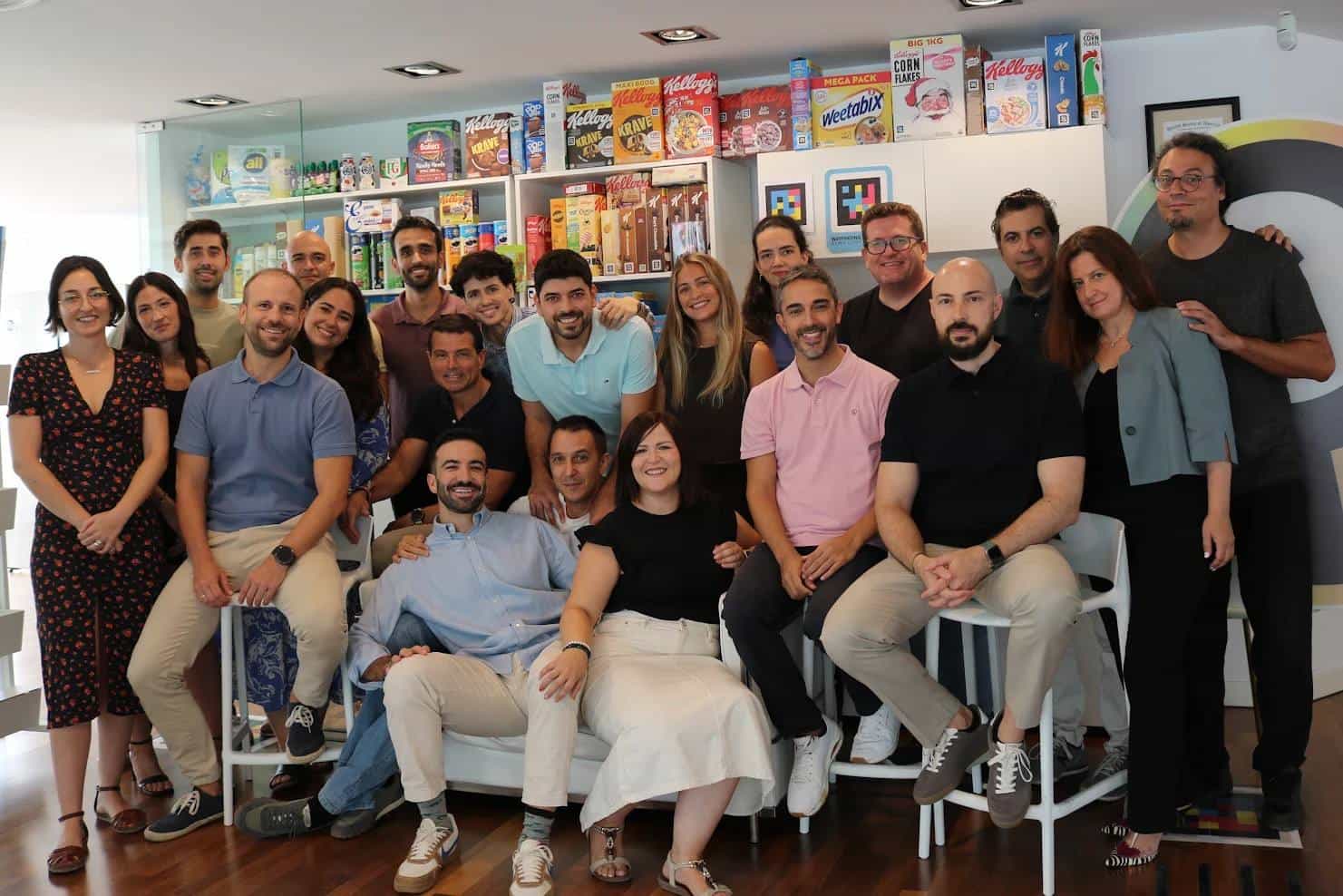 The NaviLens team at their Murcia offices, in front of shelves of packaging carrying NaviLens codes