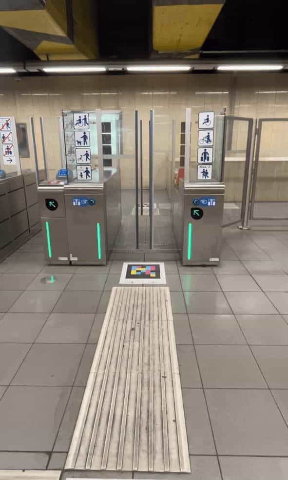 Accessible STIB/MIVB gates in Brussels with NaviLens code on the floor, embedded in the tactile line