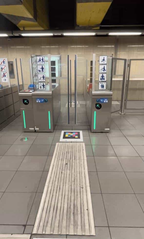 Accessible STIB/MIVB gates in Brussels with NaviLens code on the floor, embedded in the tactile line