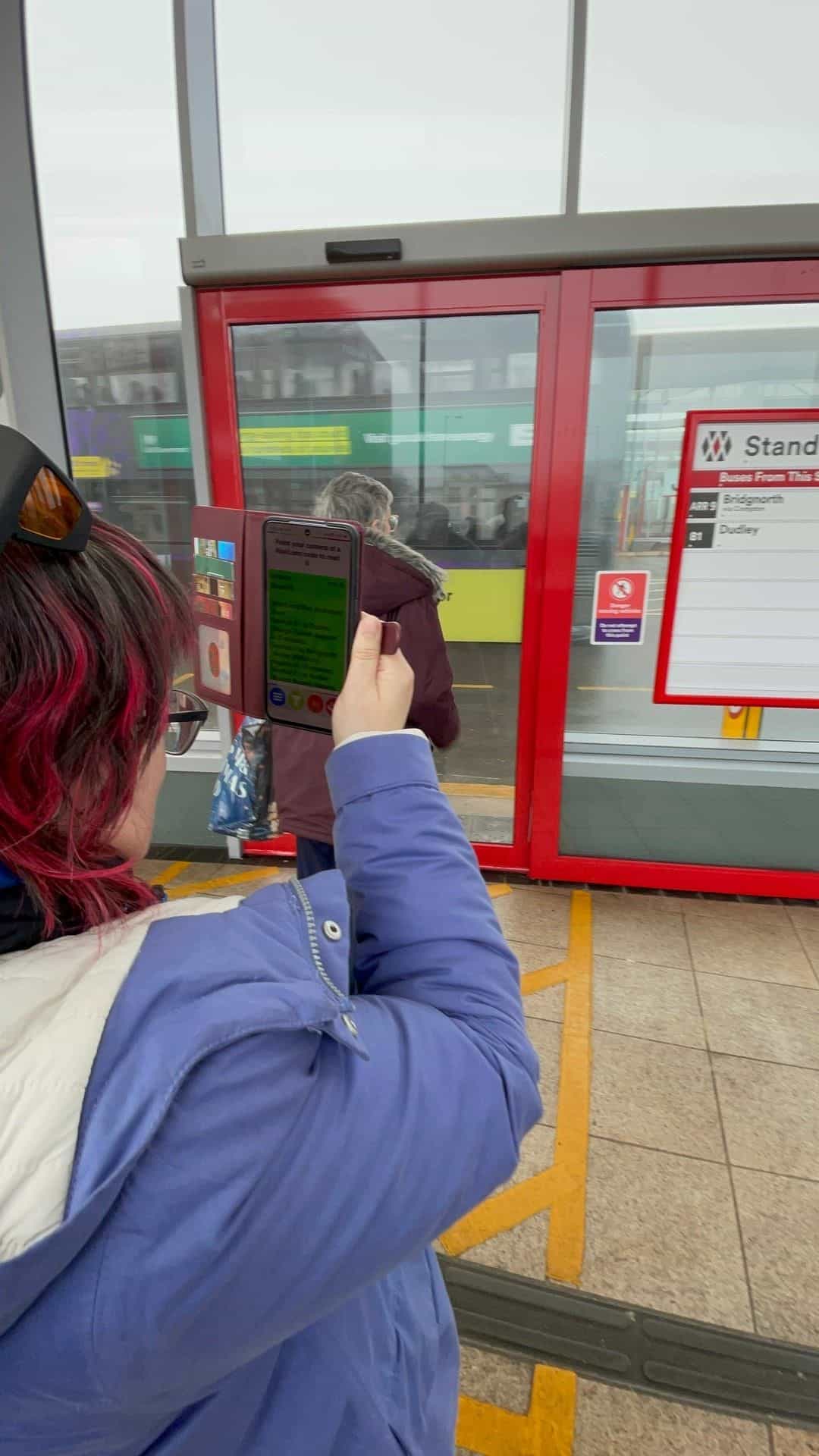User scanning a NaviLens code with NaviLens GO at Wolverhampton Bus Station Stand B