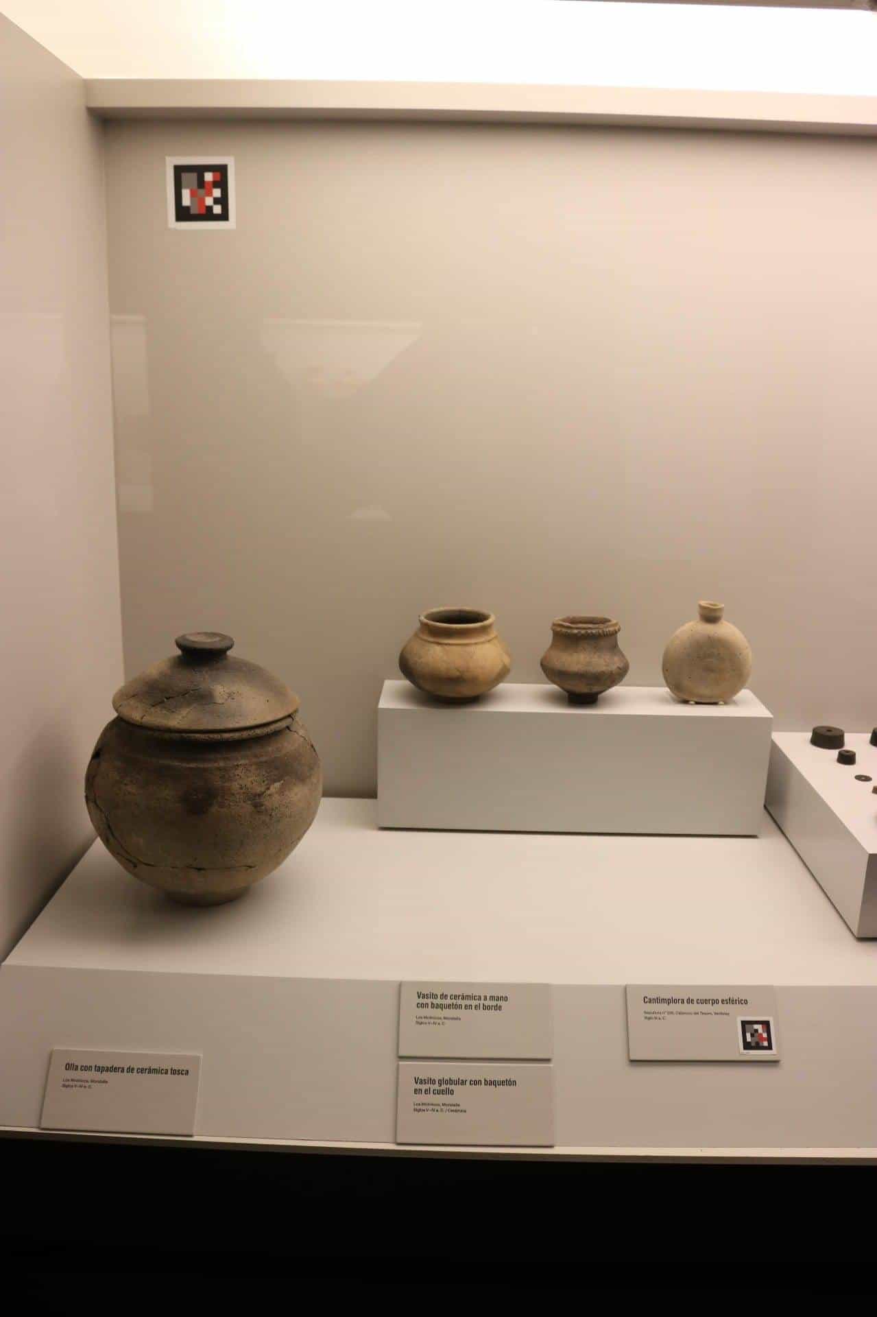 Display case with Iberian ceramics and NaviLens codes