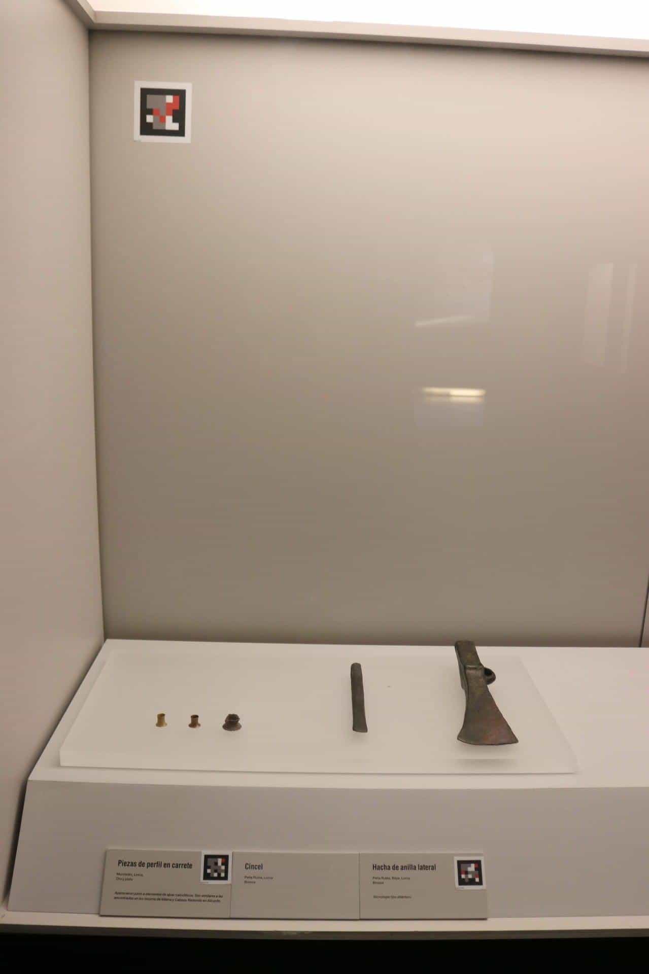 Display case with axe, chisel and NaviLens codes
